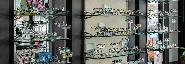 A wall display of eyeglasses for patients to try on and select their frames